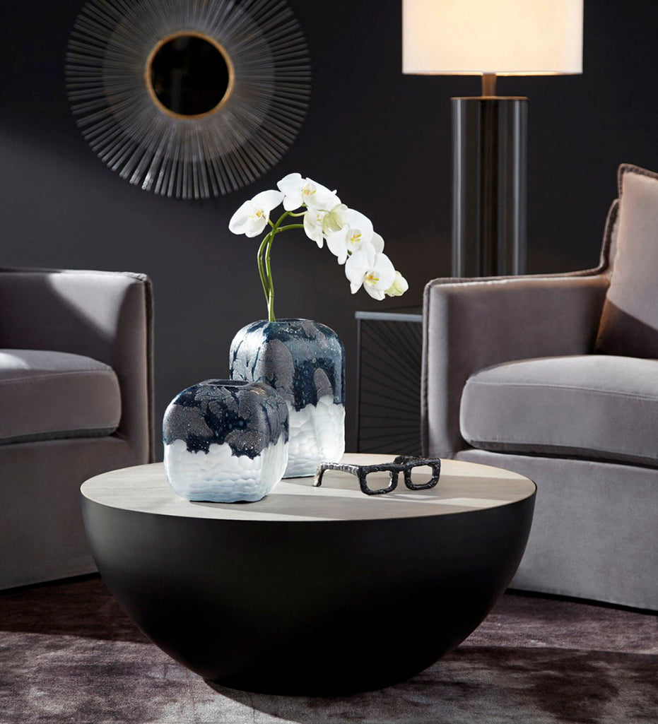 The Bosco vases in Small (with orchids) and Large displayed on a coffee table in a lit living room. 
