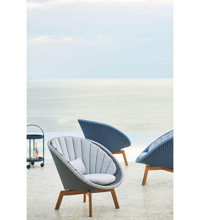lifestyle, Cane-line Peacock Midnight/Dusty Blue All Weather Rattan and Teak Outdoor Lounge Chair with Teak Legg