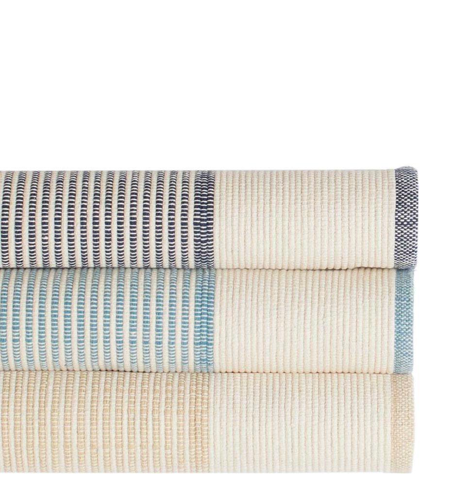 lifestyle, La Mirada Woven Cotton Rug in Navy, Asiatic Blue and Wheat (Top to Bottom)